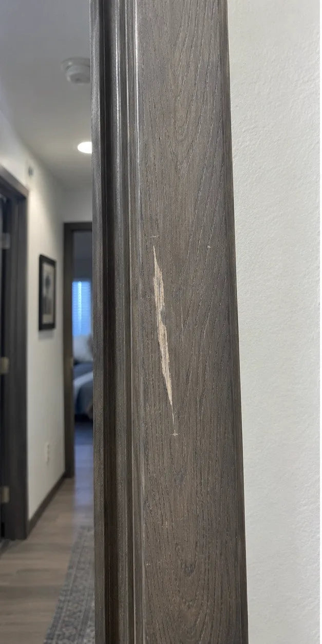 Scraped grey-stained doorframe before ScratchZero repair